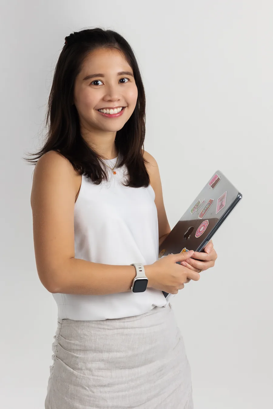 Mrs Eileen Toh holding a GPA GENIUSBOOK textbook