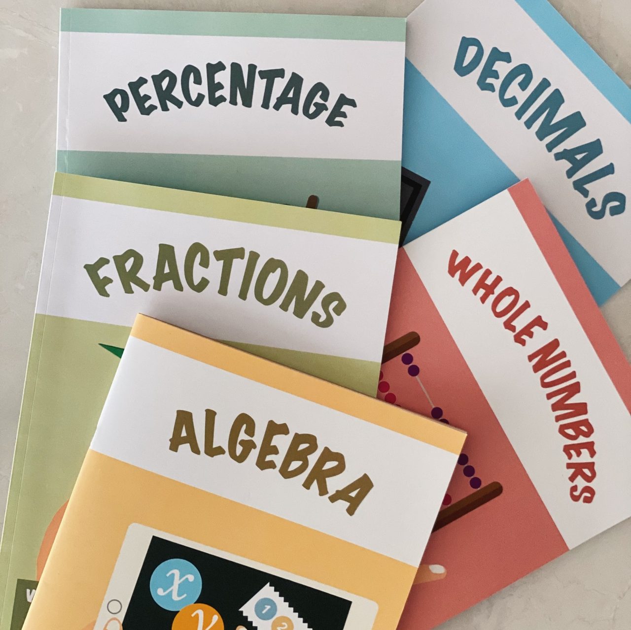 Genius Plus Academy's in-house primary math workbooks